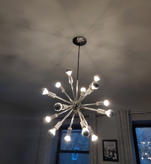 A Sputnik-style chandelier, controlled by the phone in the previous photo